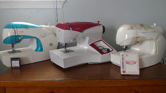 All three sewing machines on one desk